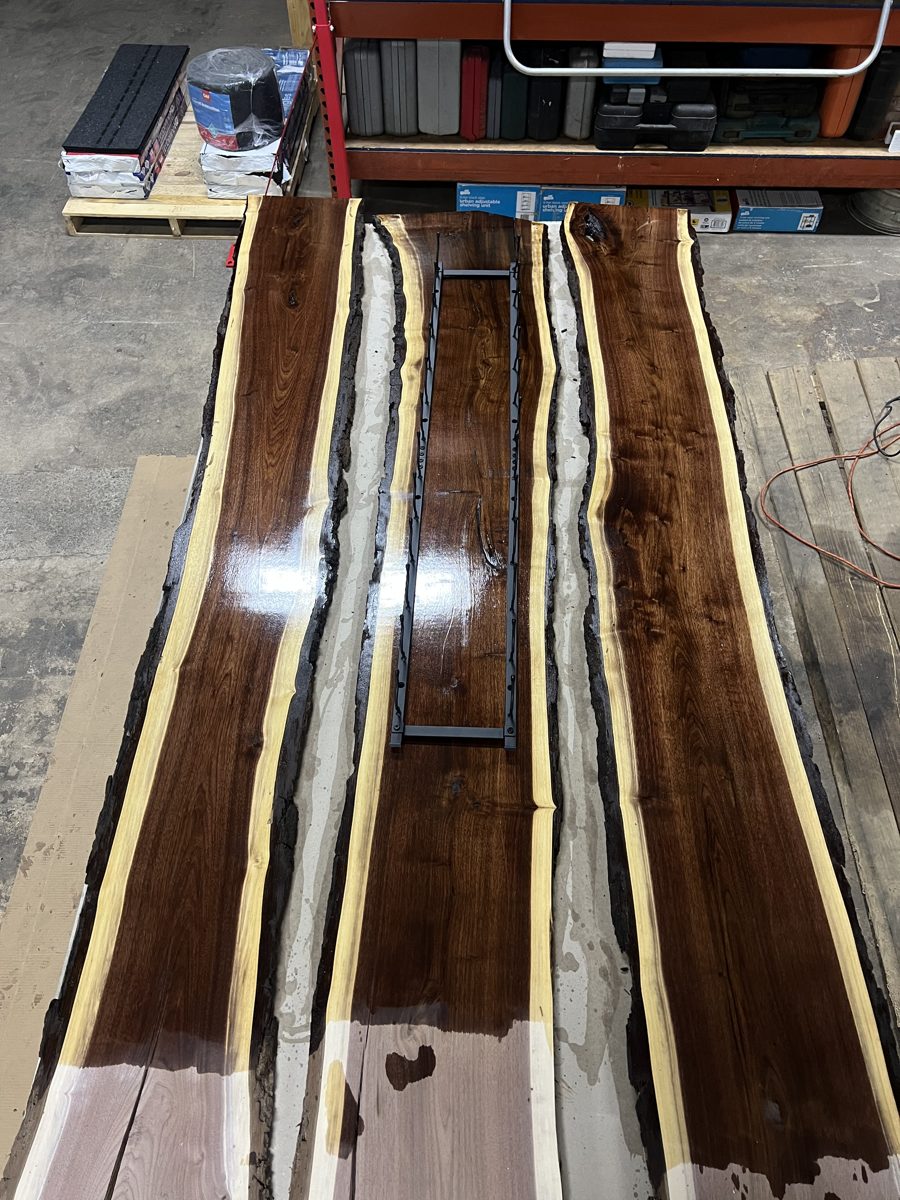 Finished walnut slab with the bottle rail laid on top